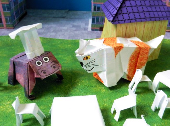 stripfiguur nijlpaard van papierkunst met een grote koksmuts stripfiguur nijlpaard van papierkunst met een grote koksmuts