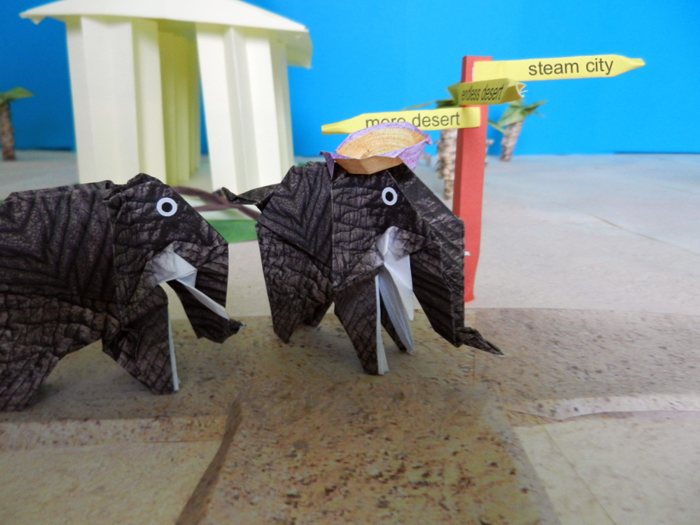 origami elephants going to a large paper city origami elephants going to a large paper city
