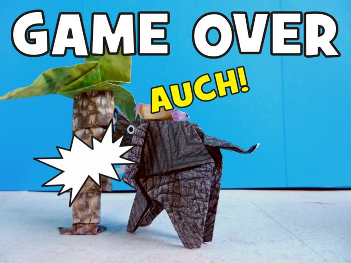 origami elephant running against a paper palm tree origami elephant running against a paper palm tree