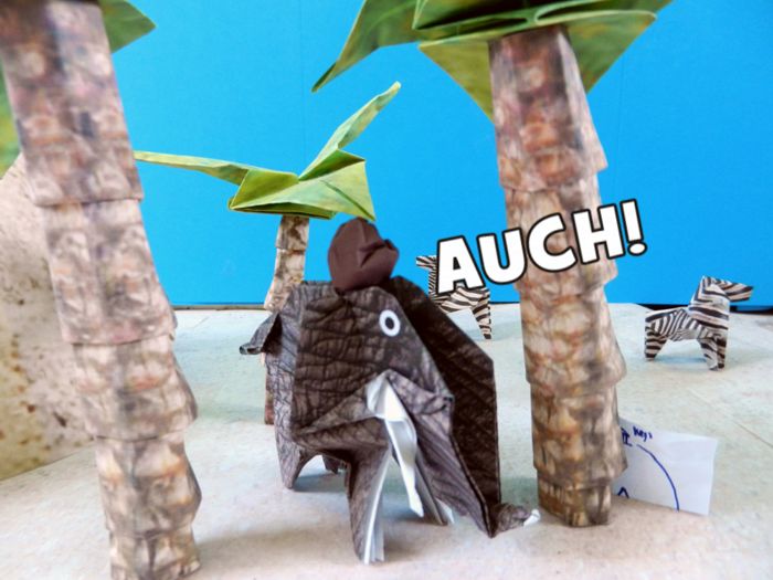 paper coconut falling on an origami elephant paper coconut falling on an origami elephant